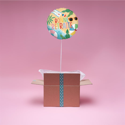 Ballon “Bonne Retraite” en hélium flottant dans une box cadeau ouverte, message personnalisé inclus.