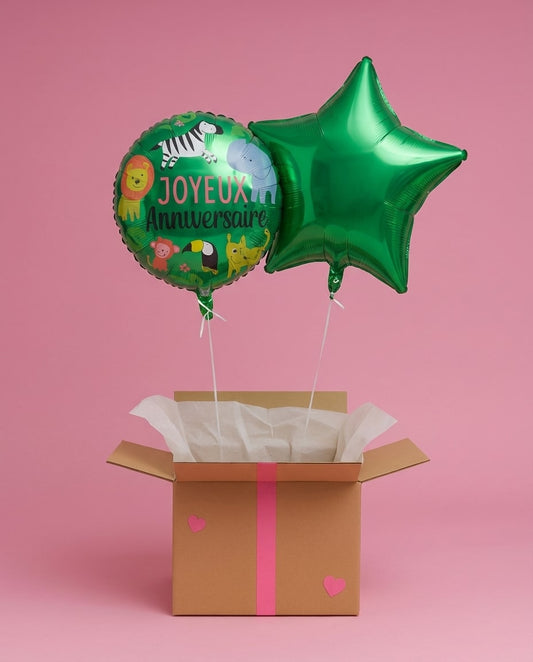 Ballons Joyeux Anniversaire et étoile verte sortant d’une box cadeau décorée, présentés sur fond rose.