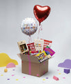 Contenu de la box anniversaire premium avec ballons, gourmandises et carte à semer